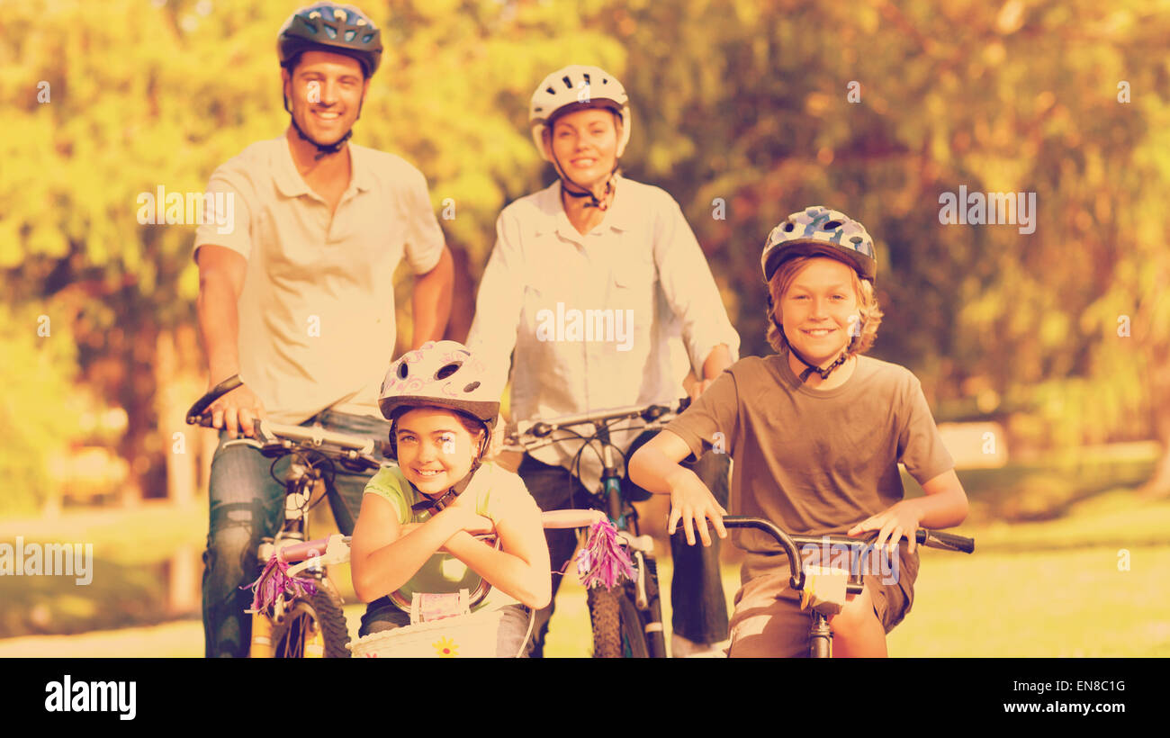 Family with their bikes in a park Stock Photo - Alamy
