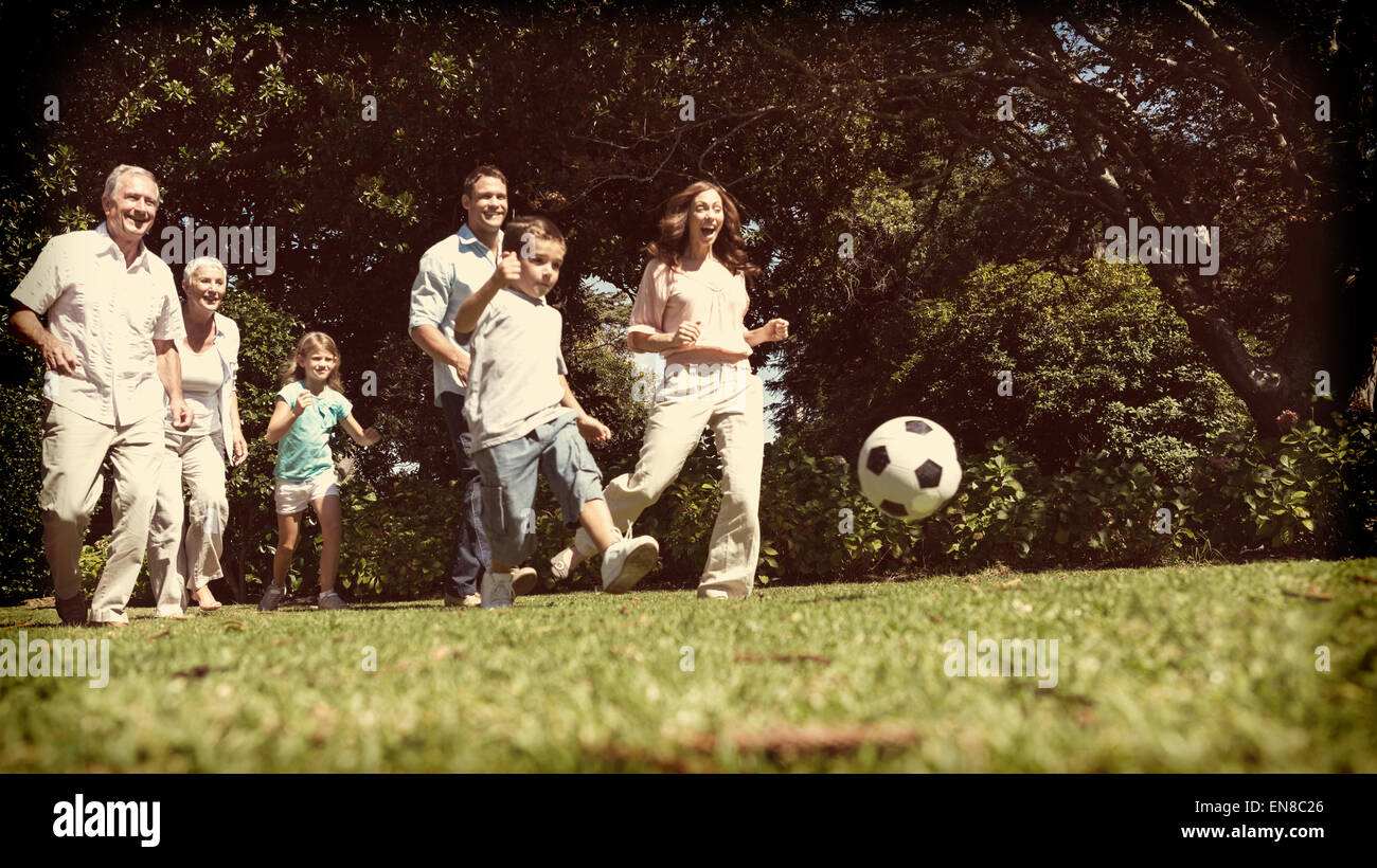 Cheerful multi generation family playing football Stock Photo