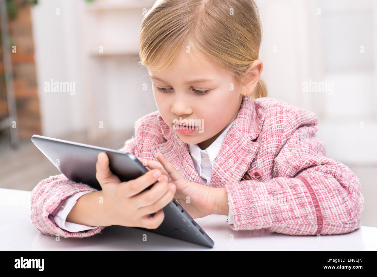 Little girl using tablet computer Stock Photo