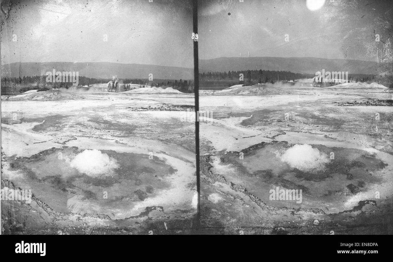 The Upper Geyser Basin in Yellowstone National Park, Wyoming, is known for its impressive geothermal features, including the iconic Grand Geyser. This area is renowned for its hot springs, geysers, and unique geological formations, attracting visitors worldwide for its natural beauty. Stock Photo