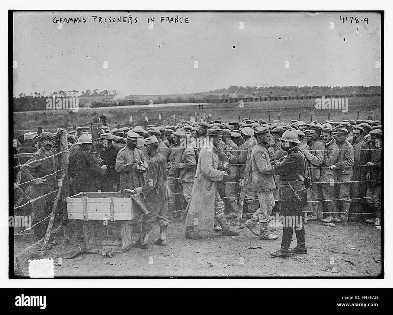 The image depicts German prisoners of war held in France during World War I or II. The photograph captures their conditions and the context of their internment in a foreign country. Such images are significant historical records, shedding light on the wartime experience of prisoners and the aftermath of military conflicts. Stock Photo