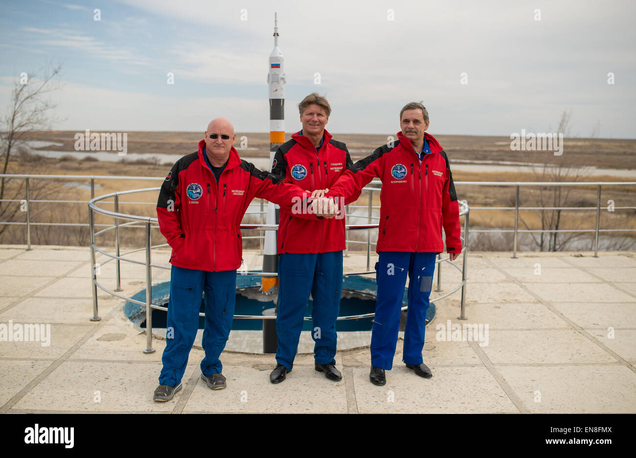 Expedition 43 NASA Astronaut Scott Kelly, left, Russian Cosmonauts Gennady Padalka, center, and Mikhail Kornienko of the Russian Federal Space Agency (Roscosmos) pose for a group photo near a model of the Soyuz rocket during media day, Saturday, March 21, 2015 at the Cosmonaut Hotel in Baikonur, Kazakhstan. Kelly, Padalka, and Kornienko are preparing for launch to the International Space Station in their Soyuz TMA-16M spacecraft from the Baikonur Cosmodrome in Kazakhstan March 28, Kazakh time (March 27 Eastern time.) As the one-year crew, Kelly and Kornienko will return to Earth on Soyuz TMA-1 Stock Photo