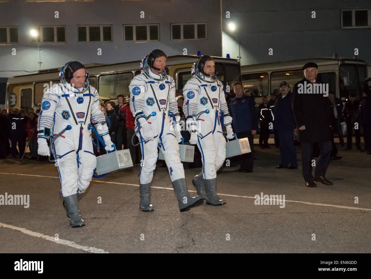 Expedition 43 NASA Astronaut Scott Kelly, left, and Russian Cosmonauts Gennady Padalka, center, and Mikhail Kornienko of the Russian Federal Space Agency (Roscosmos) depart building 254 for their launch onboard the Soyuz TMA-16M spacecraft to the International Space Station Friday, March 27, 2015 in Baikonor, Kazakhstan. Kelly, Padalka, and Kornienko launched to the ISS from the Baikonur Cosmodrome in Kazakhstan March 28, Kazakh time (March 27 Eastern time.) As the one-year crew, Kelly and Kornienko will return to Earth on Soyuz TMA-18M in March 2016.   (NASA/Victor Zelentsov) Stock Photo