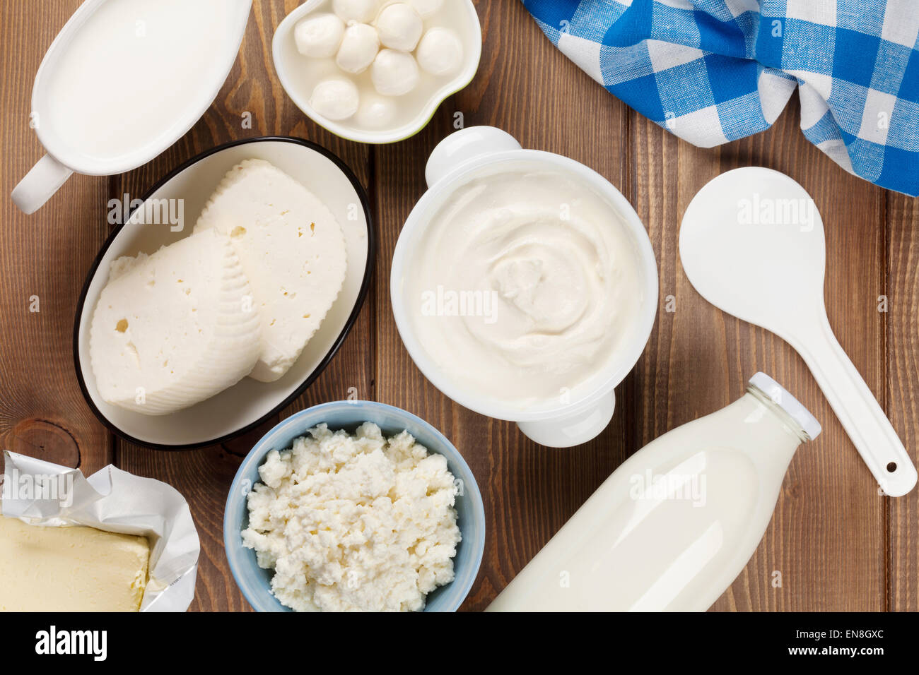 Dairy products on wooden table. Sour cream, milk, cheese, yogurt and butter. Top view Stock Photo