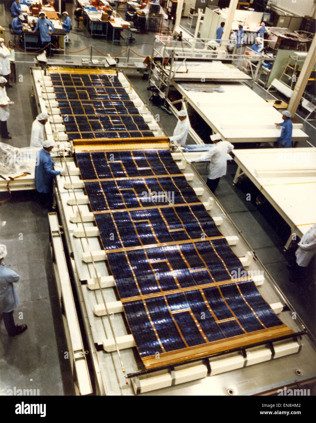 The Hubble Space Telescope is powered by huge solar arrays. To test the solar cell blankets, engineers deployed them on a water table. The arrays are mounted on opposite sides of the telescope, on the forward shell of the Support Systems Module. Each array stands on a 4-foot mast that supports a retractable wing of solar panels 40-feet (12.1-meters) long and 8.2-feet (2.5-meters) wide, in full extension. The arrays rotate so that the solar cells face the Sun as much as possible to harness the Sun's energy. The solar arrays were designed to be replaced in orbit. (NASA/MSFC Image) Stock Photo