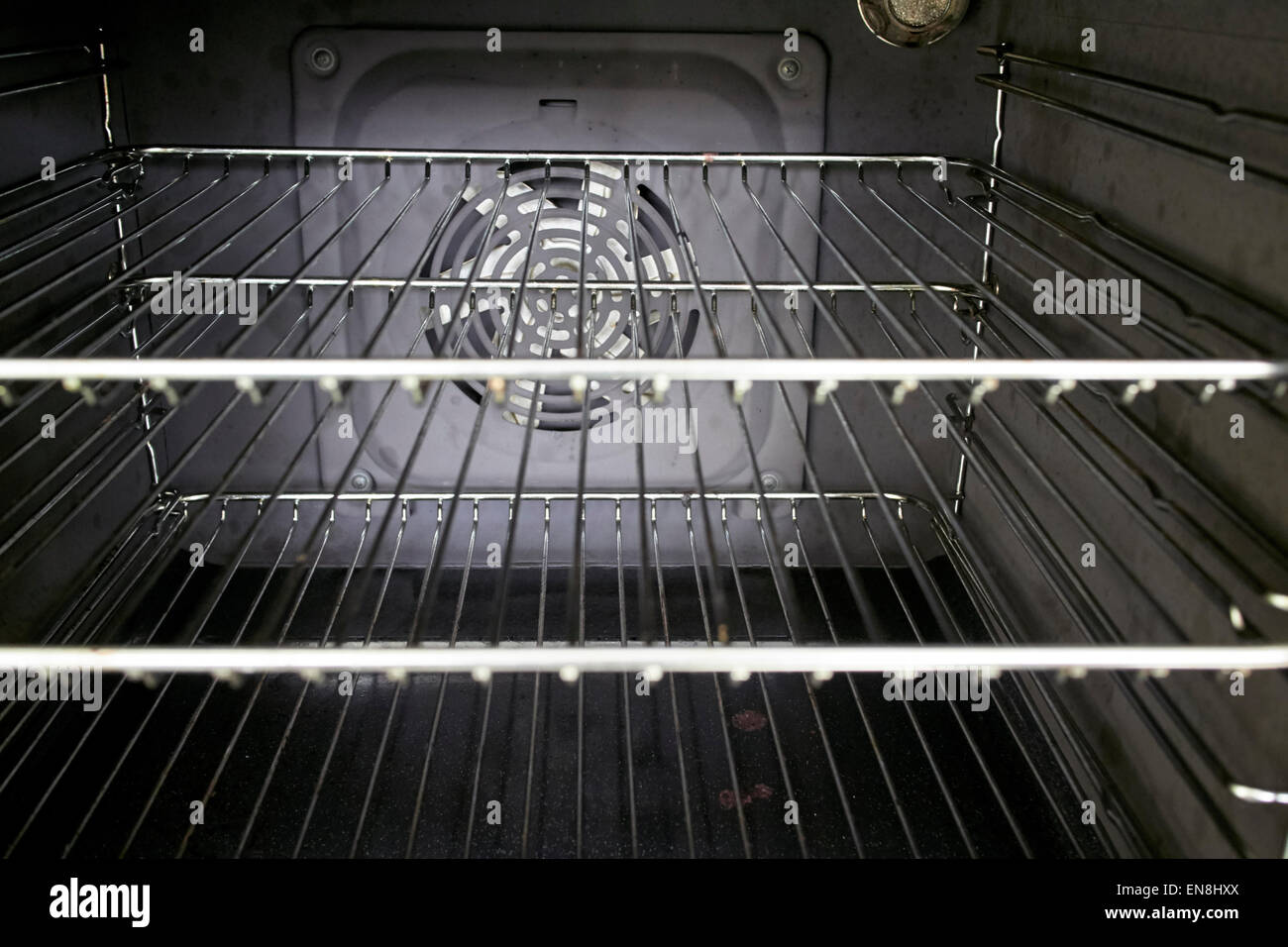 interior of a home kitchen fan assisted oven with clean metal grill shelves Stock Photo