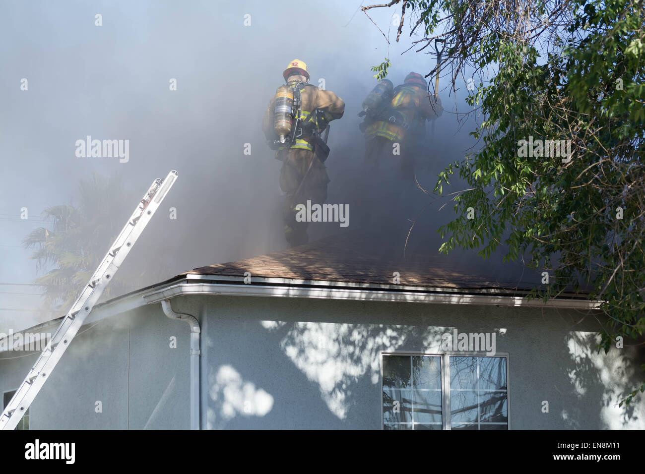 Burbank, CA USA 28 APR 2015 Burbank CA firefighters in smoke at a house fire. Stock Photo