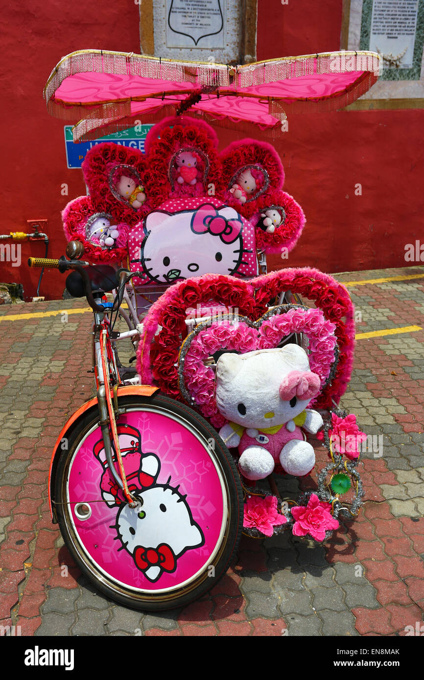 Decorated kitsch cycle trishaw rickshaw with soft toys in Malacca, Malaysia Stock Photo