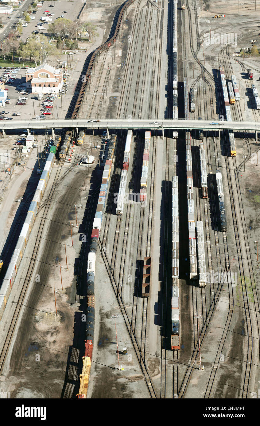 Train cars and locomotives in a rail switching yard. Stock Photo