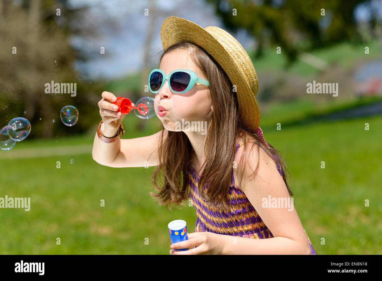 a little girl making soap bubbles in nature Stock Photo - Alamy