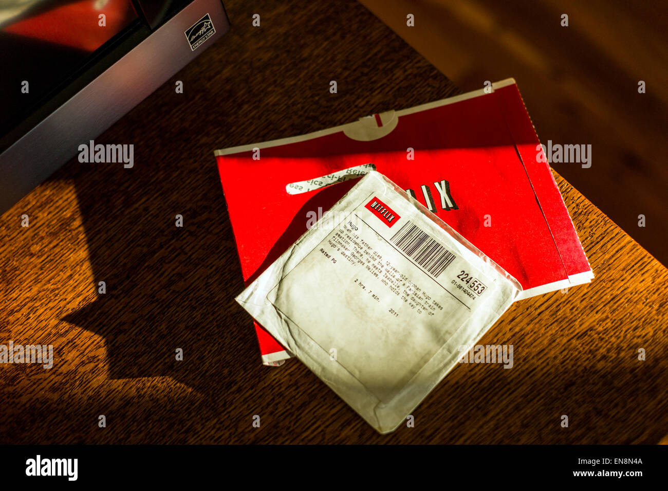 Late afternoon sunlight streams across a Netflix movie DVD Stock Photo