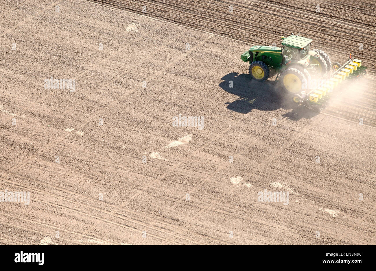 An aerial view of farm machinery planting sugar beets in the fertile farm fields of Idaho. Stock Photo