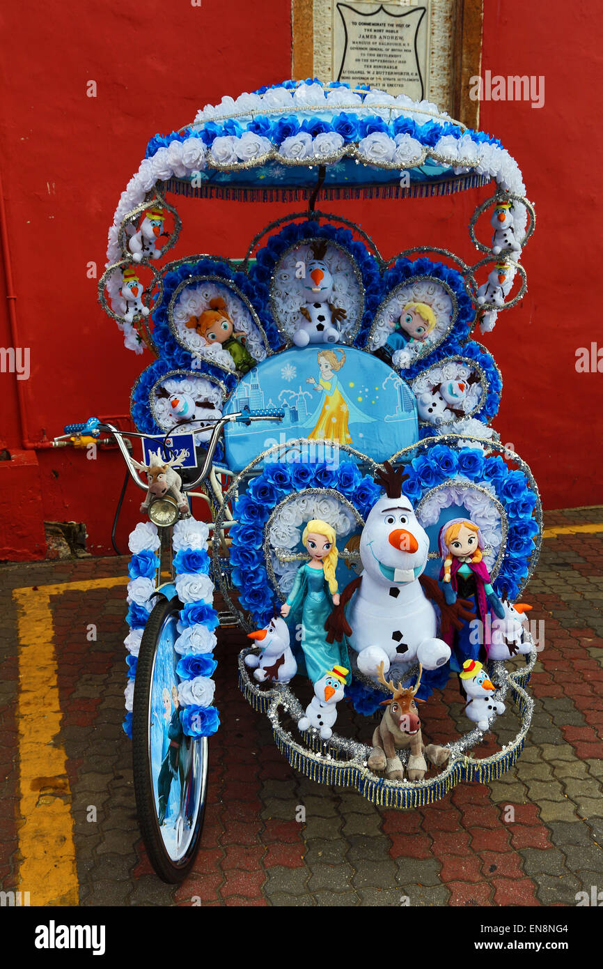 Decorated kitsch cycle trishaw rickshaw with soft toys in Malacca, Malaysia Stock Photo