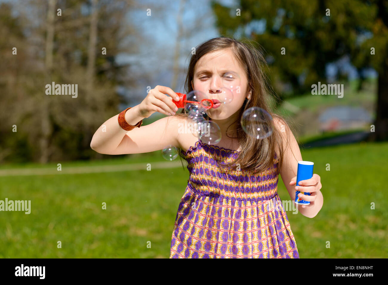 a little girl making soap bubbles in nature Stock Photo - Alamy