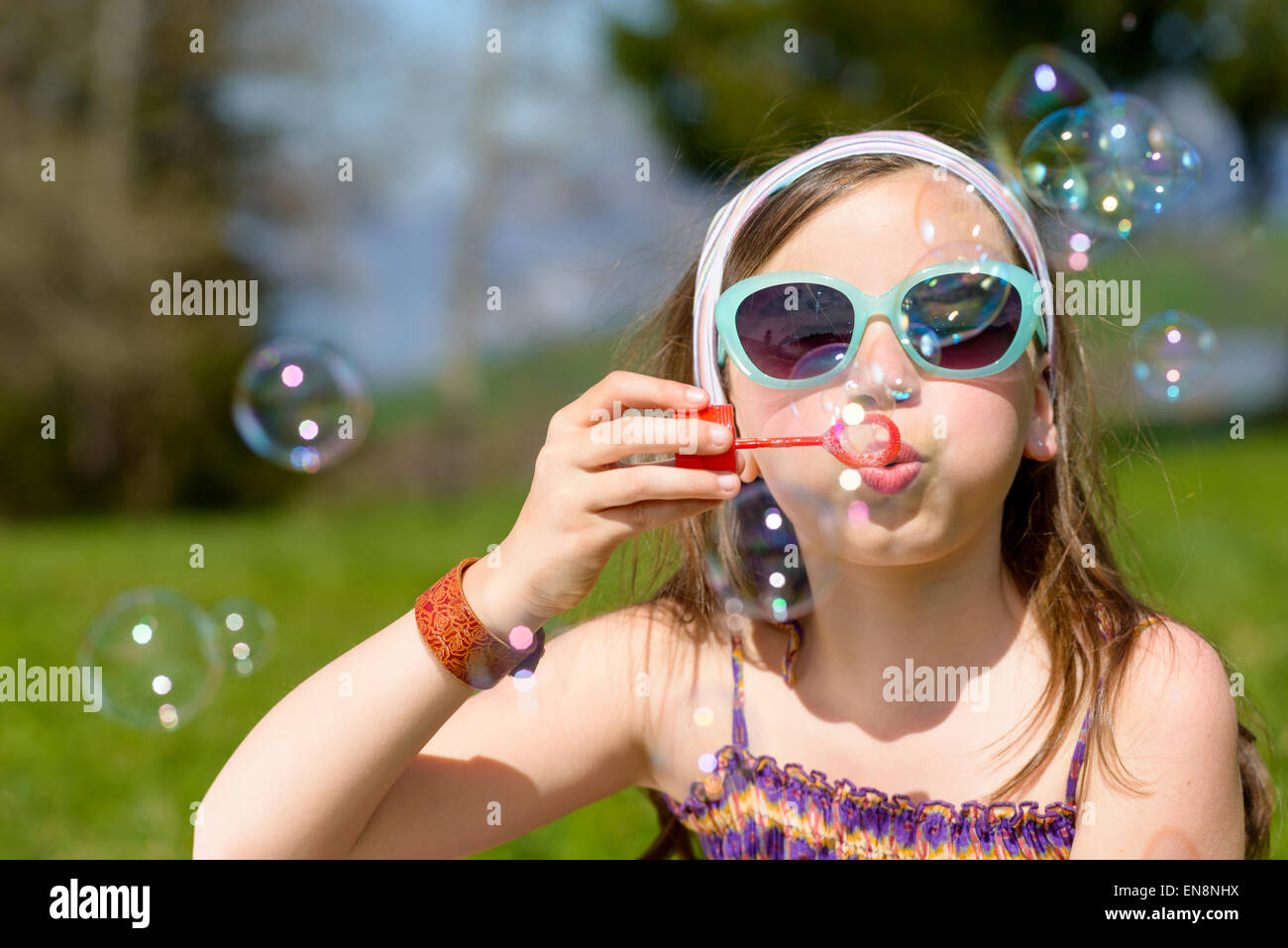 a little girl making soap bubbles in nature Stock Photo - Alamy