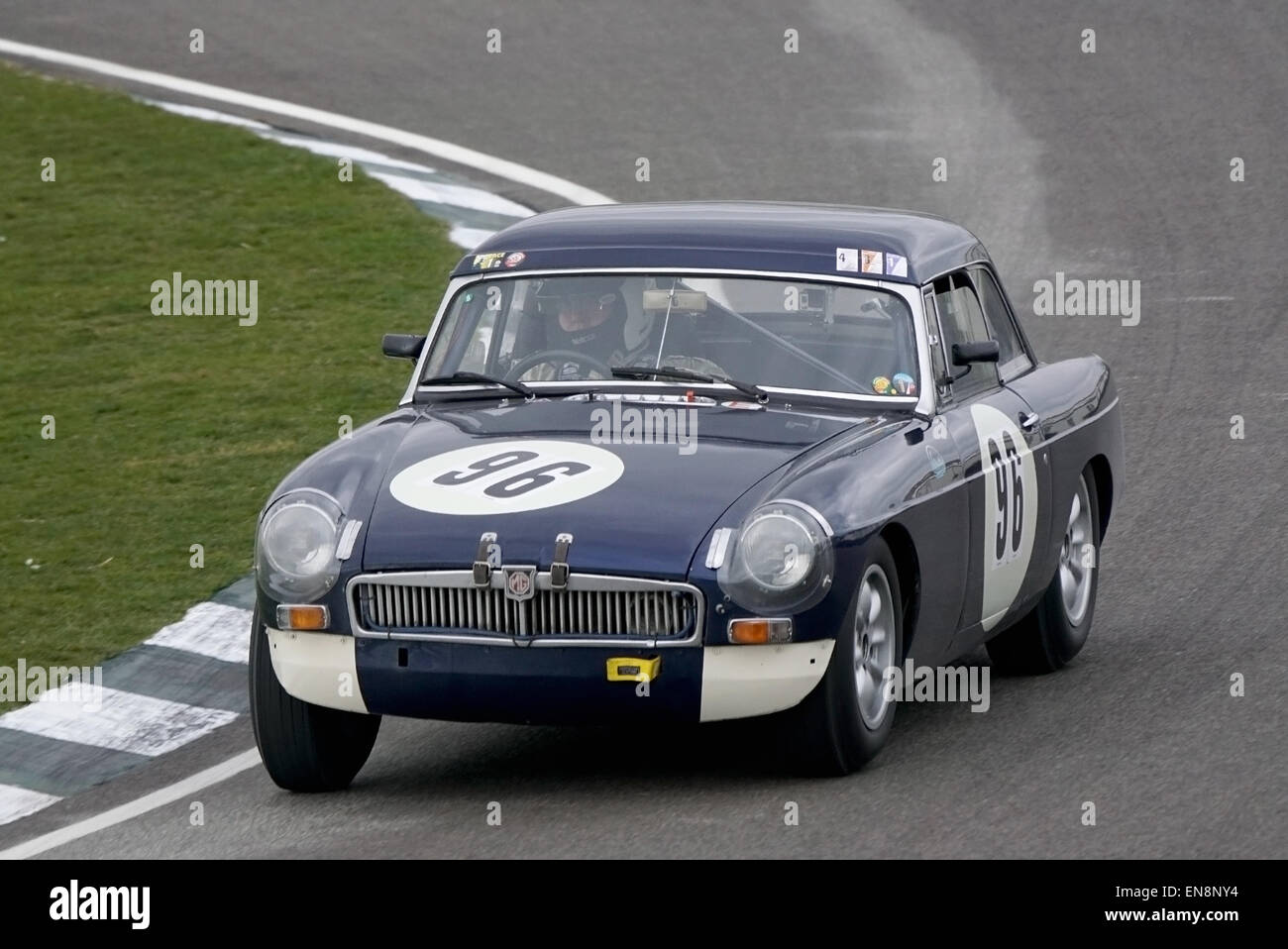 Richard Evans 1963 MGB cornering hard through Woodcote during the Les Leston Cup race at the Goodwood 73rd Members Meeting Stock Photo