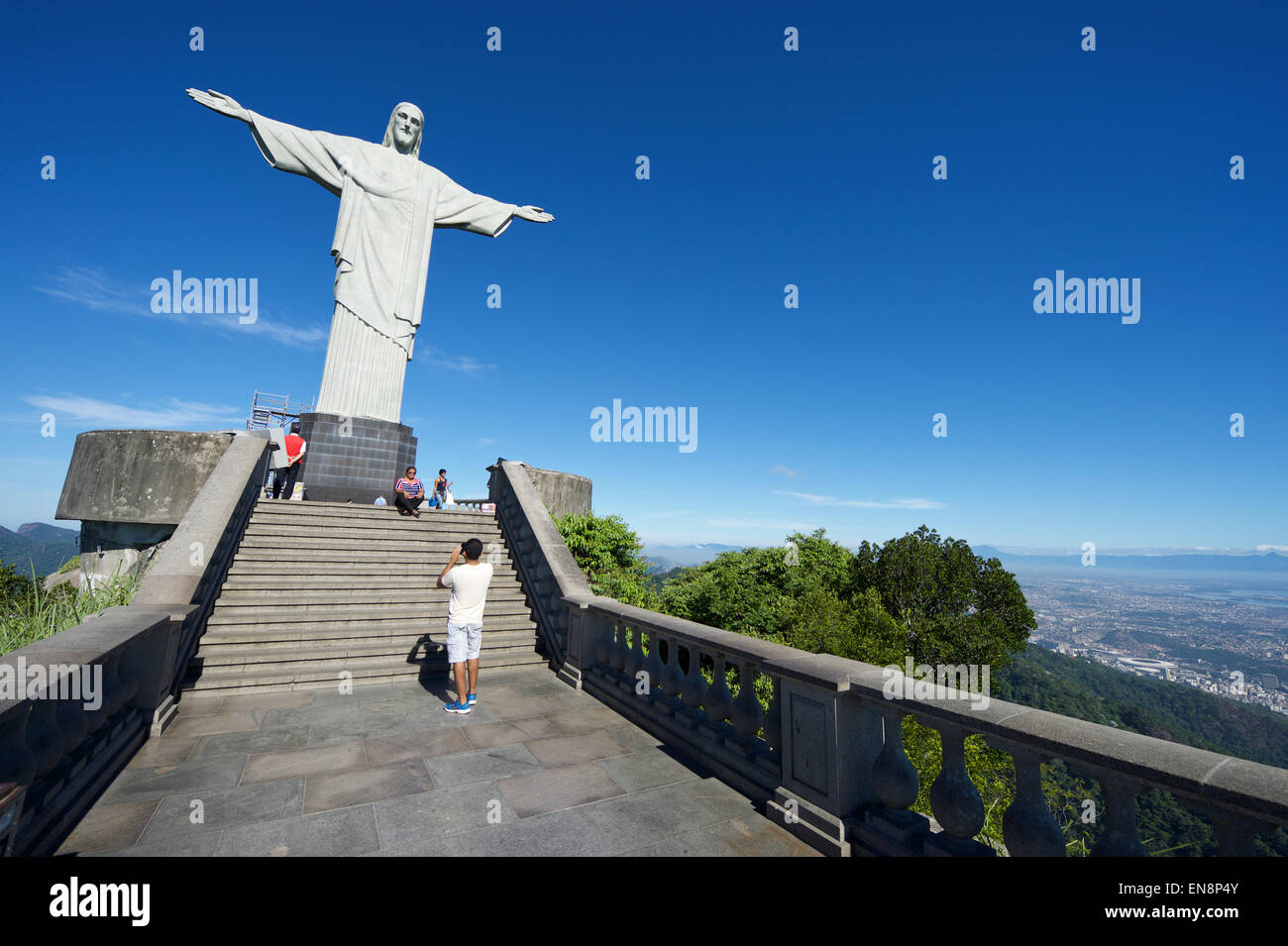 RIO DE JANEIRO, BRAZIL - MARCH 05, 2015: The first group of tourists arrive at the Statue of Christ the Redeemer at Corcovado. Stock Photo