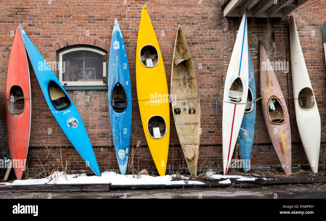 Old kayaks on display outside Capricorn Kayaks, downtown historic Salida, Colorado, USA Stock Photo