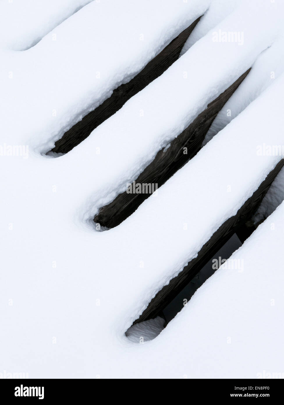 Snow creates patterns on old rail structure. Stock Photo