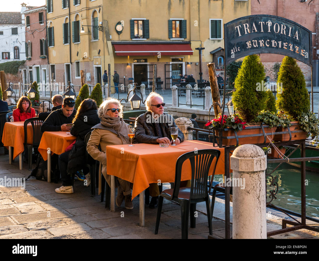 People enjoying food & drink at an outdoor cafe, Venice, Italy Stock