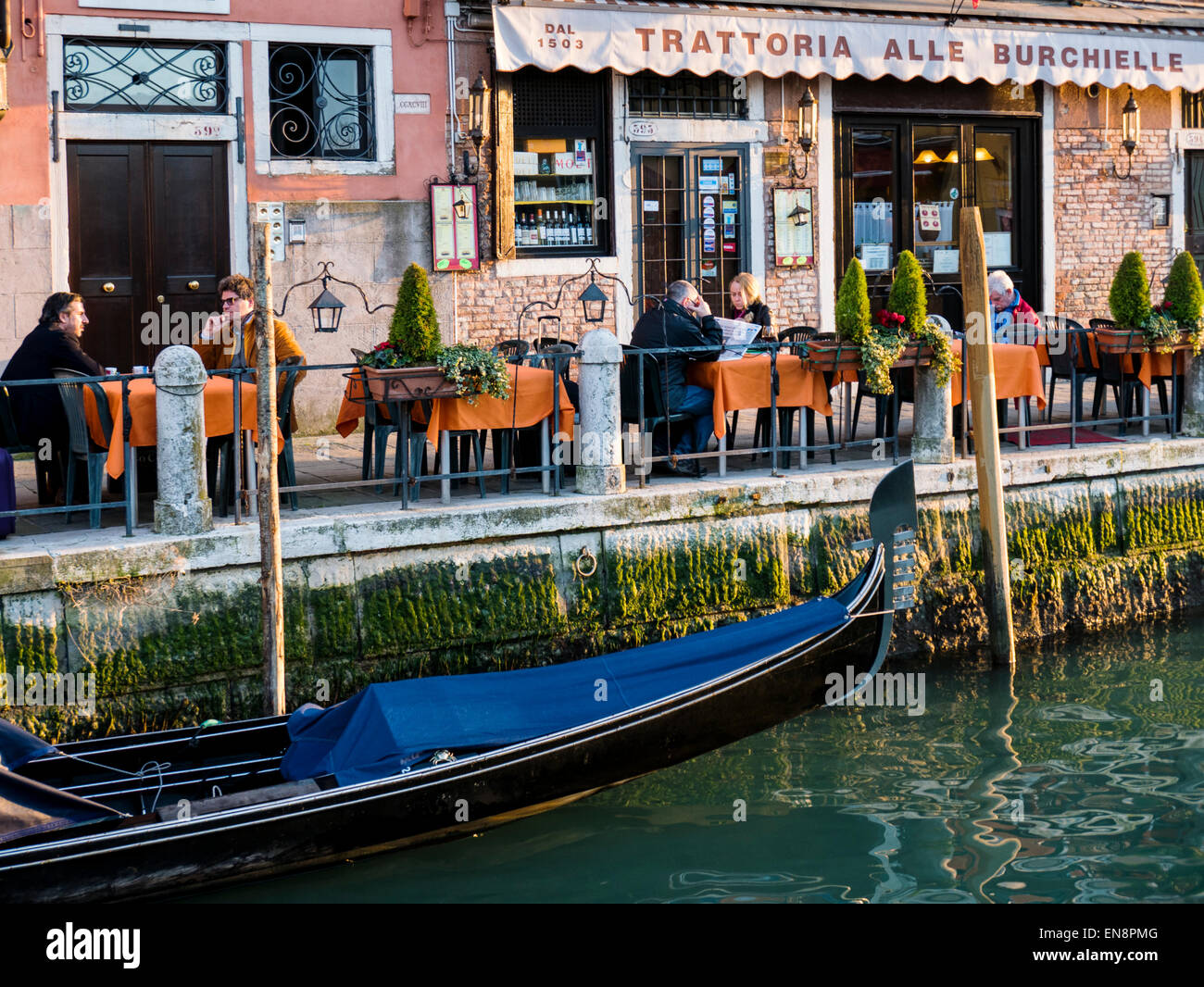 People enjoying food & drink at an outdoor cafe, Venice, Italy Stock Photo