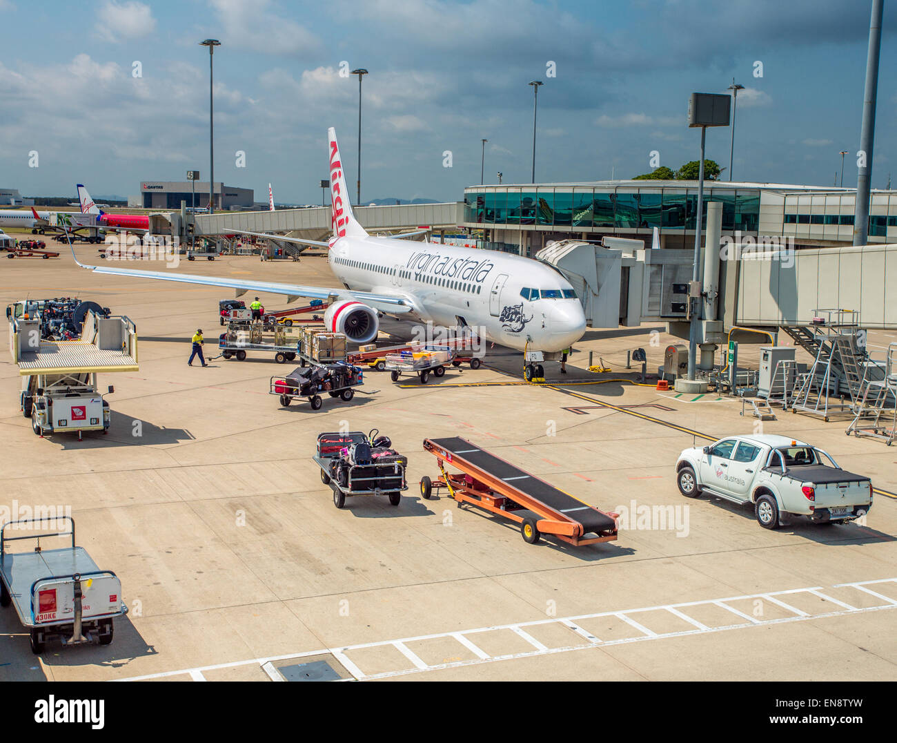 Aircraft baggage handlers load luggage and cargo on Virgin Australia aircraft. Stock Photo