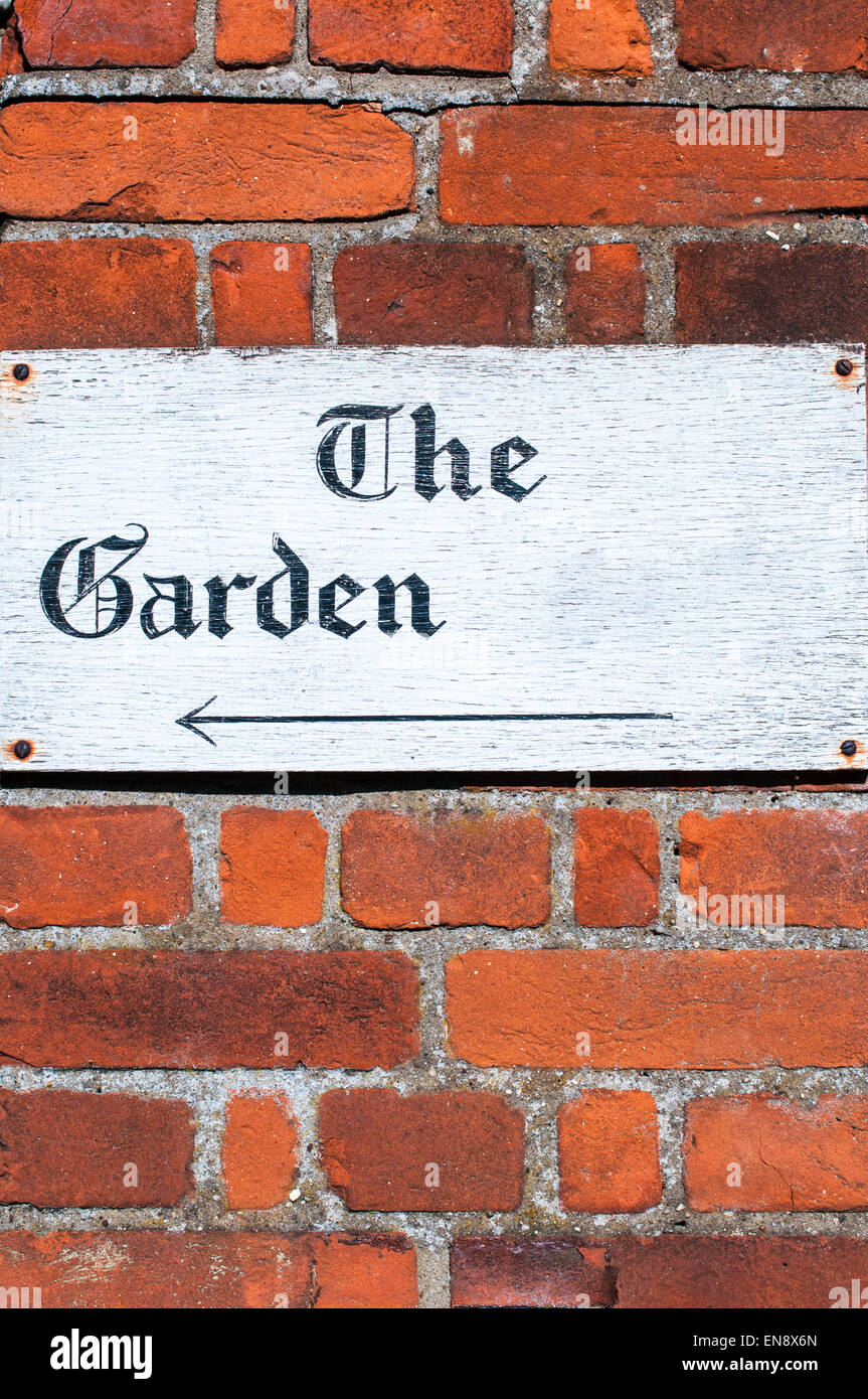 Sign for 'The Garden' on a brick wall Stock Photo