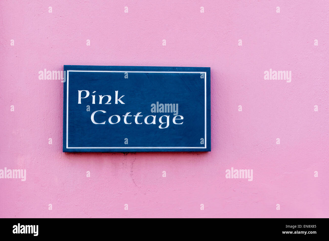 Sign for 'Pink  Cottage' engraved on a tile pasted on wall Stock Photo