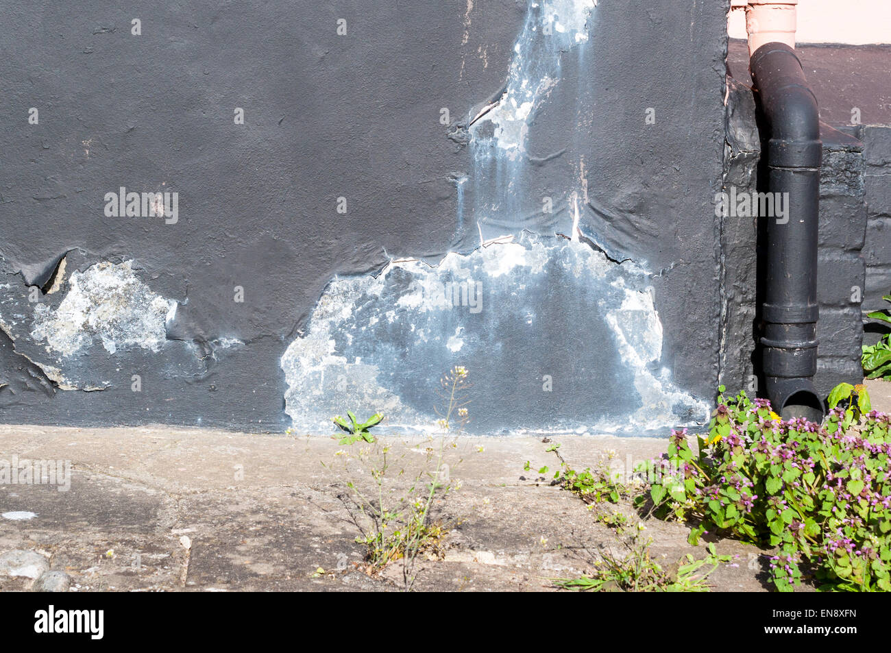 Drain and Peeling paint from exterior wall surface cracking due to