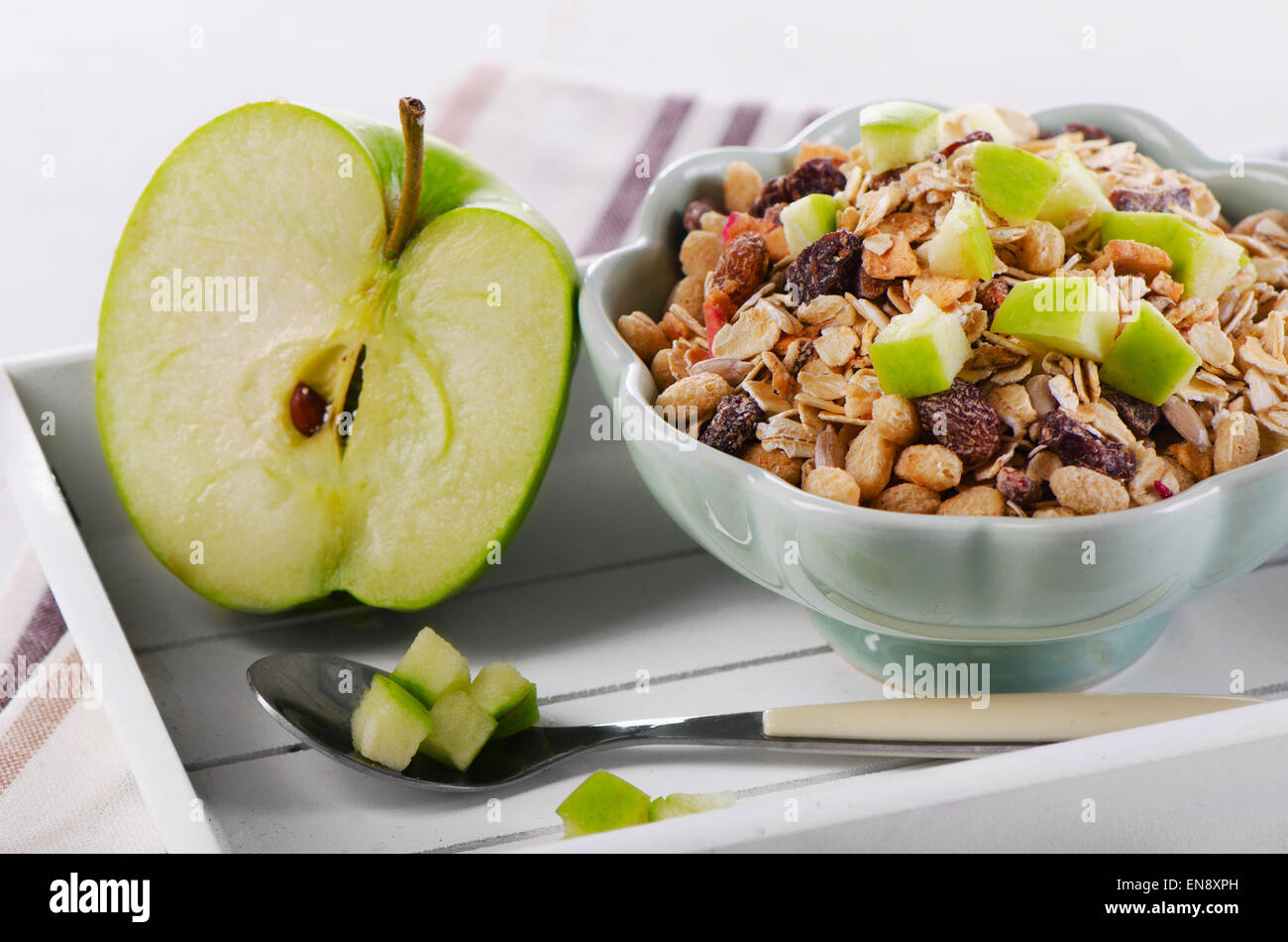 Bowl of muesli and  green apple for a nealthy breakfast Stock Photo