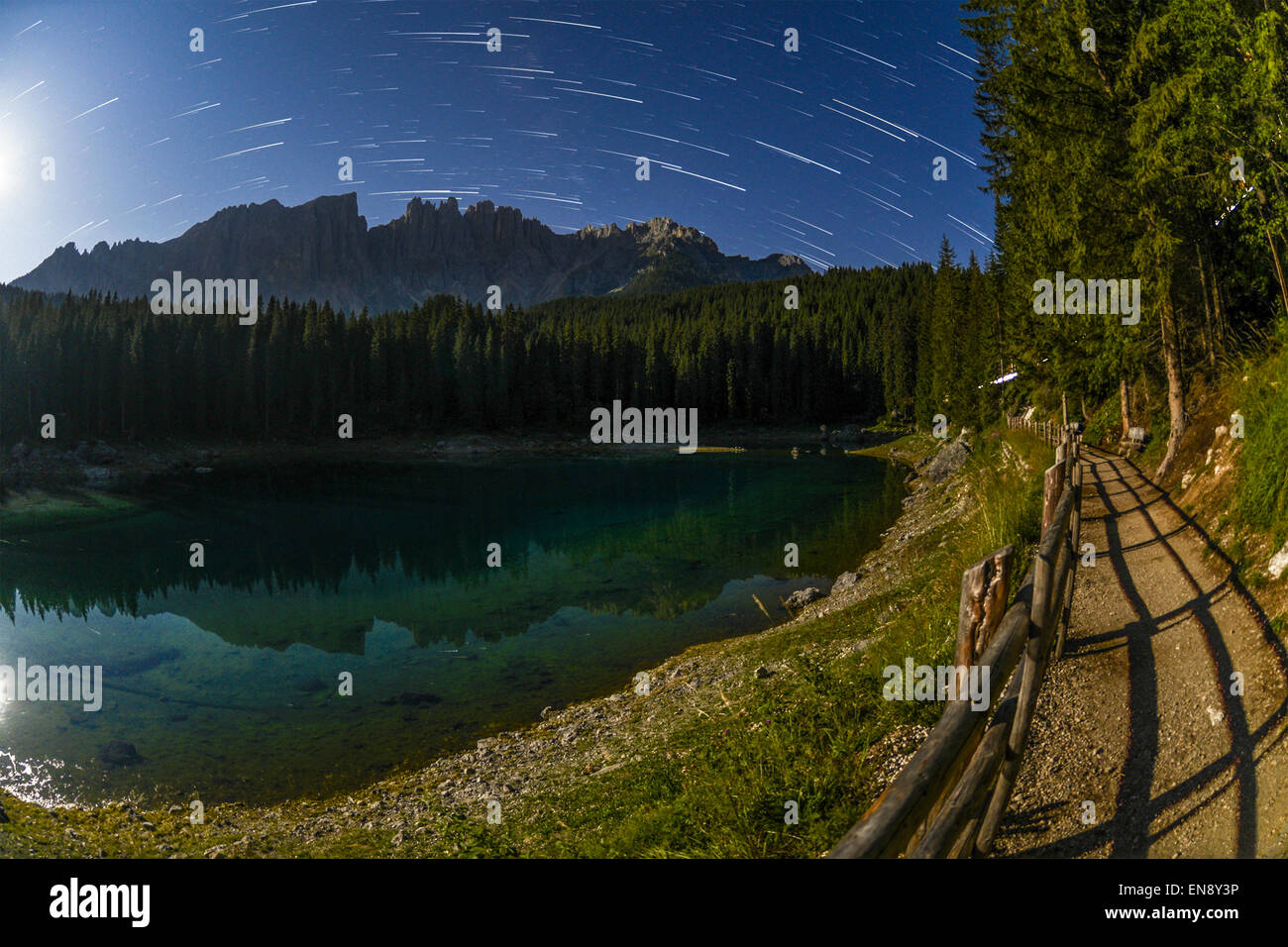 Carezza lake and Latemar with star trails, Dolomites - Italy Stock Photo