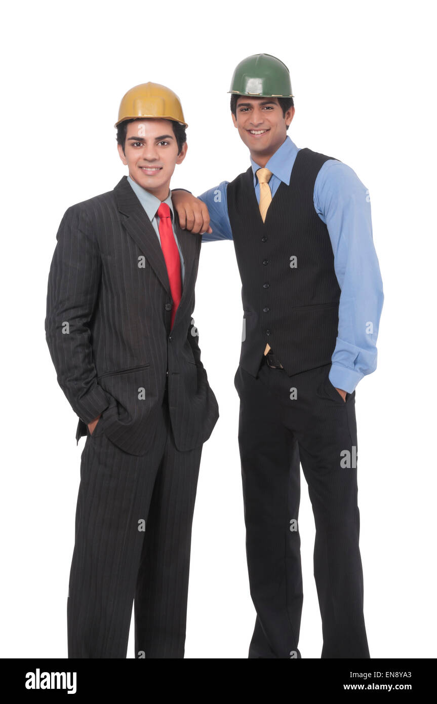 Close up of two asian professional men standing together wearing helmets Stock Photo