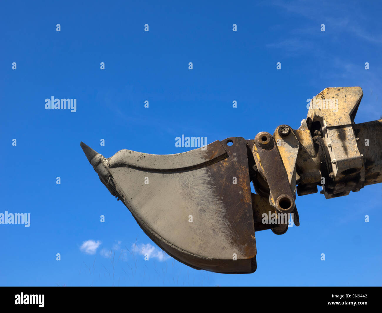 Excavator bucket against the blue sky Stock Photo Alamy