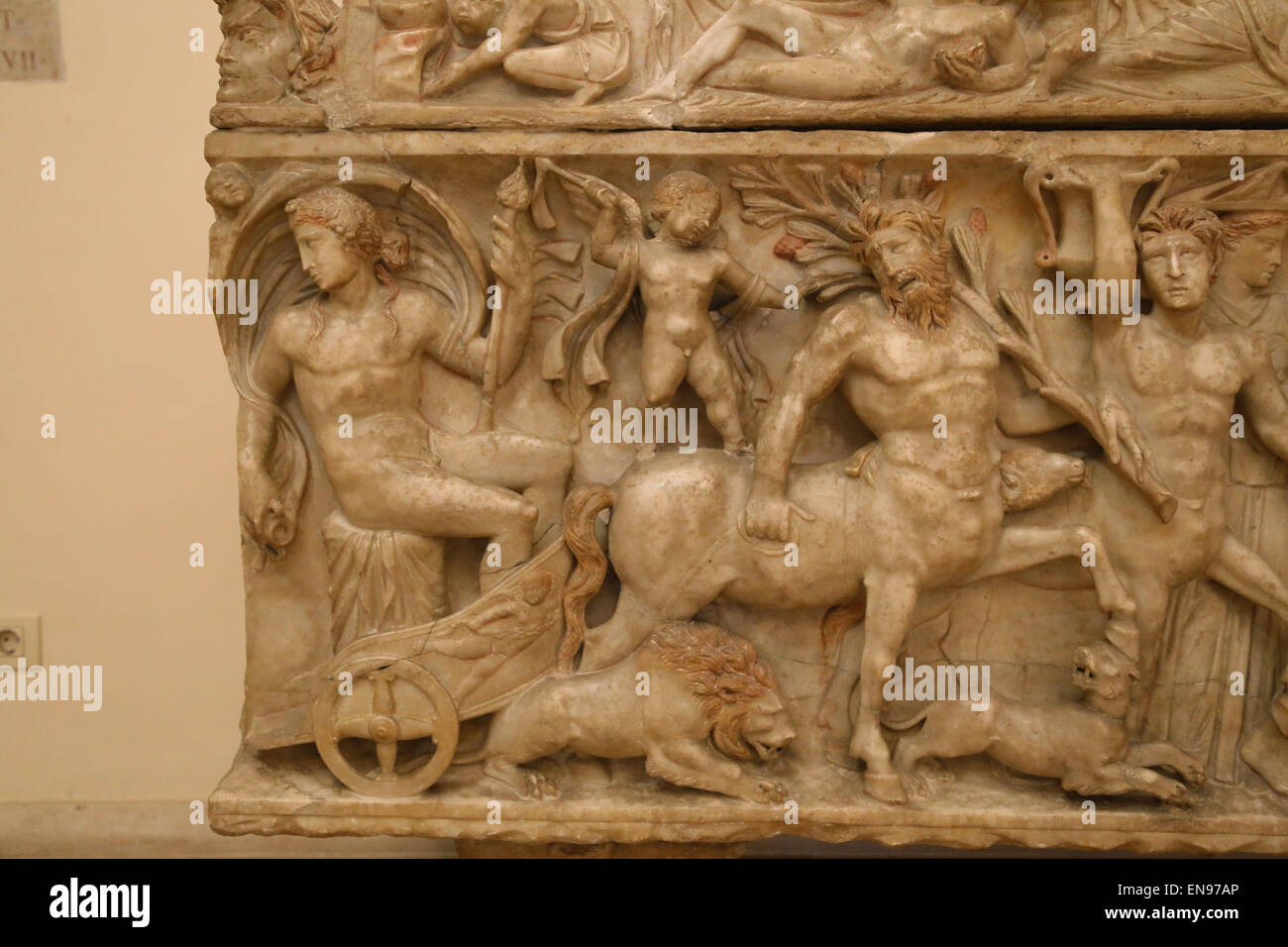 Roman art. Sarcophagus with Dionysian procession. Dionysus on the chariot,  Cupido, lion, centaurs and panther. Detail. Stock Photo