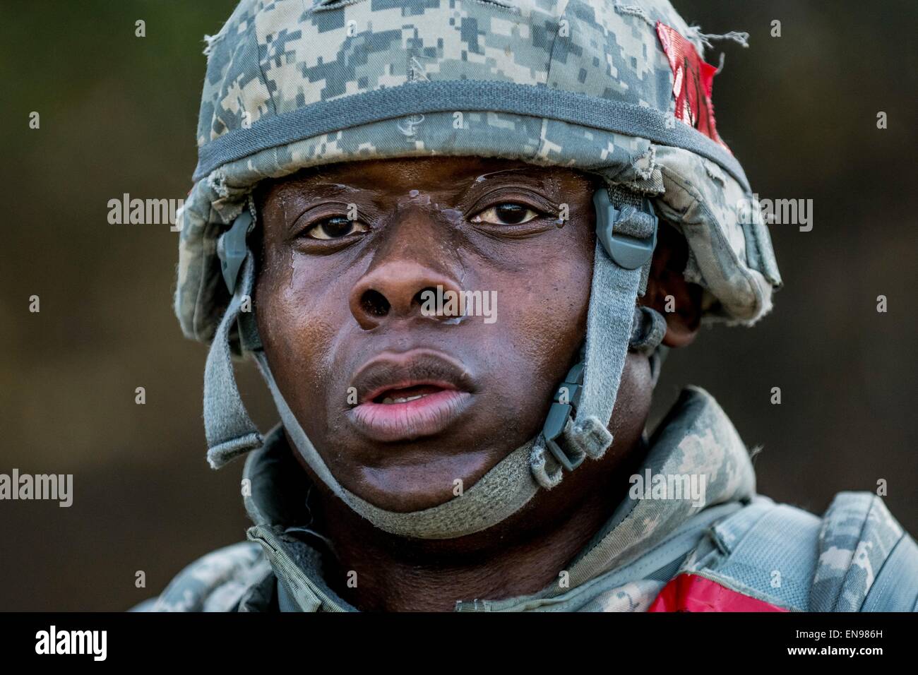 Spc. Sean Crooks with the 668th Engineer Company, poses for a portrait after completing a 4-mile ruck march carrying approximately 65 pounds worth of gear and equipment April 28, 2015 at Fort McCoy, Wisconsin. Stock Photo