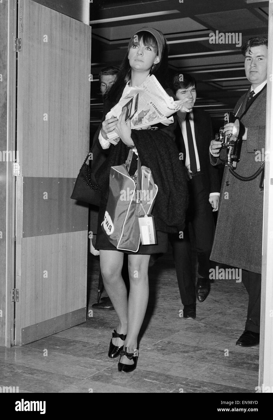 Chrissie Shrimpton, girlfriend of Mick Jagger of The Rolling Stones, flying out to join him at the end of their US tour. 4th December 1965 Stock Photo