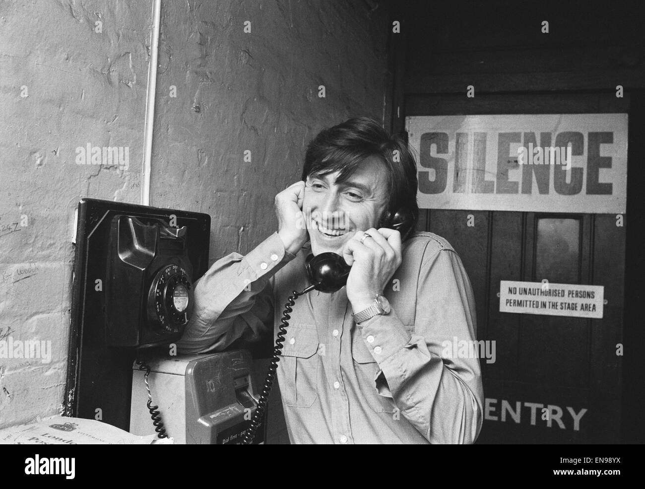 Singer Vince Hill who is performing in 'Tonights the Night' at the Talk of the Town Theatre, seen here back stage during a break in rehearsals on the stage door telephone ringing his wife at home. She is expecting their first child within the next few day Stock Photo