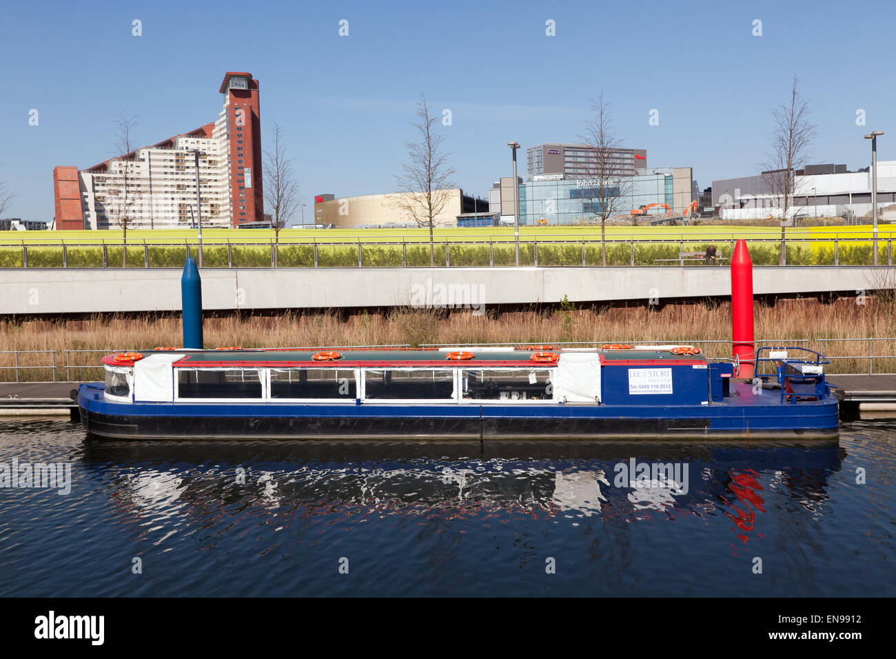 Queen Elizabeth Olympic Park Boat Tours, offered by the Lee and Stort Boat Company, on the river Lee Stock Photo