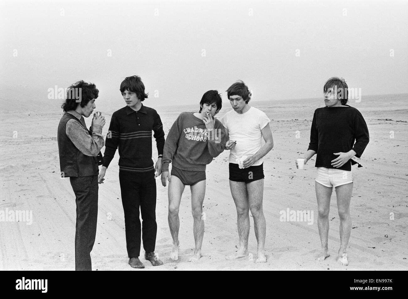 The Rolling Stones. Bill Wyman, Mick Jagger, Keith Richards, Charlie Watts and Brian Jones seen here posing on Malibu beach. According to the photographers ' The boys had some hamburgers and played football and were happy to be beside the sea' However it Stock Photo