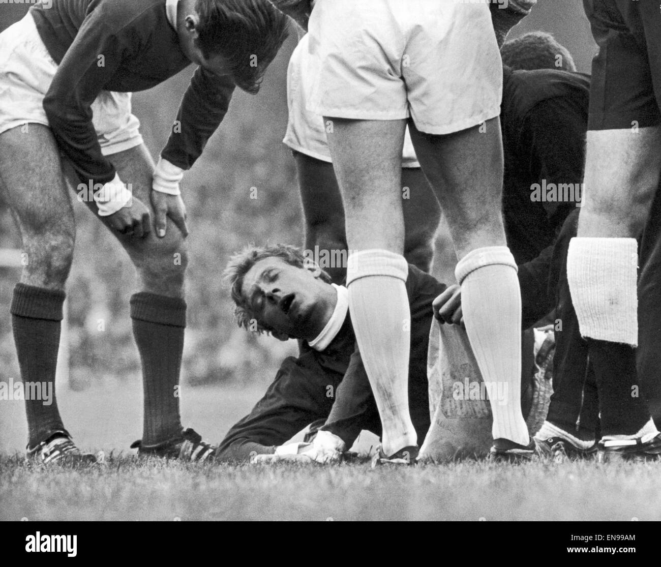 English League Division One match at Old Trafford. Manchester United 1 v Sunderland 0. Denis Law of United lies on the ground after a collision with Charlie Hurley at Old Trafford. 10th October 1964. Stock Photo