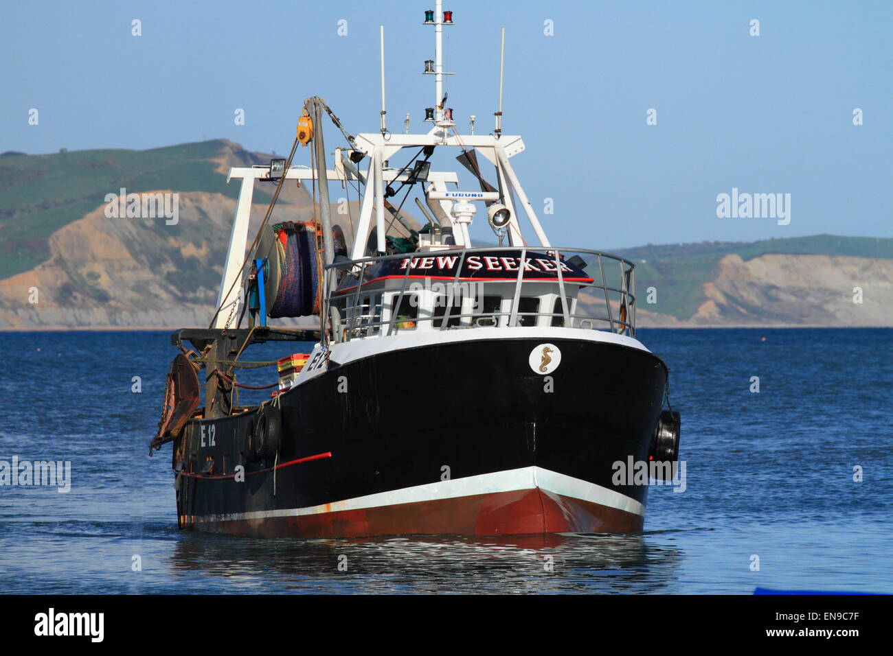 Fishing boat, returning to Lyme Regis Harbour, Dorset, England, UK ...