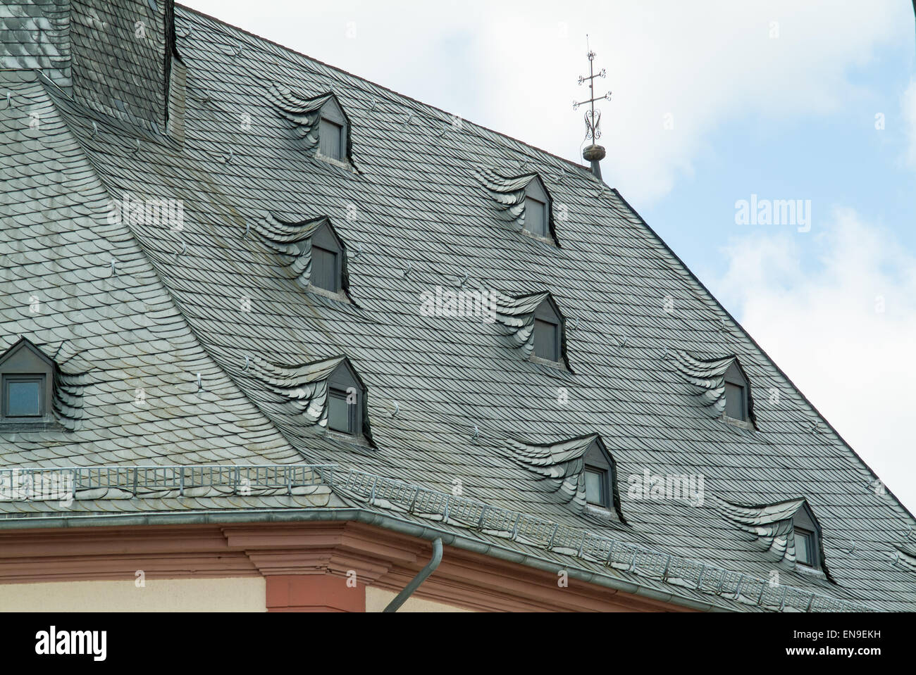 Grey Tiled Roof With Many Small Dormer Windows Stock Photo