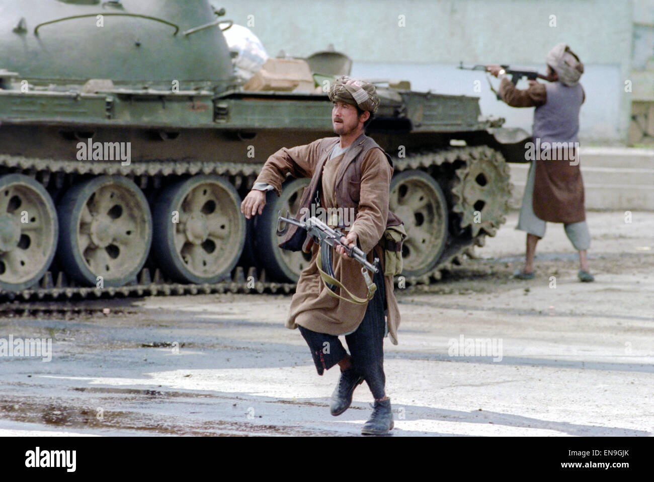 An Afghan mujahideen fighter with Jamayat-E-Islami forces during fighting against Hezb-i Islami following the fall of the capital April 19, 1992 in Kabul, Afghanistan. Fighting between mujahideen factions began almost immediately after they captured the city. Stock Photo