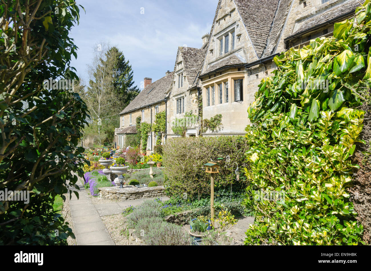 Row of traditional stone cottages in the Cotswold village of BourtonontheWater Stock Photo