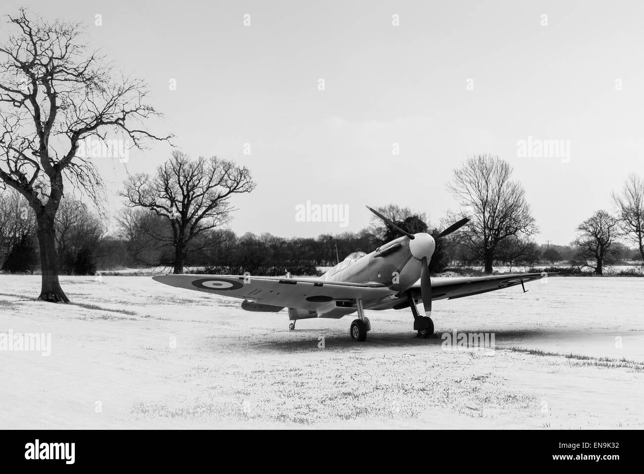 RAF Supermarine Spitfire at rest in a snowy field in the winter of 1940/41. Black and white version of this image. Stock Photo