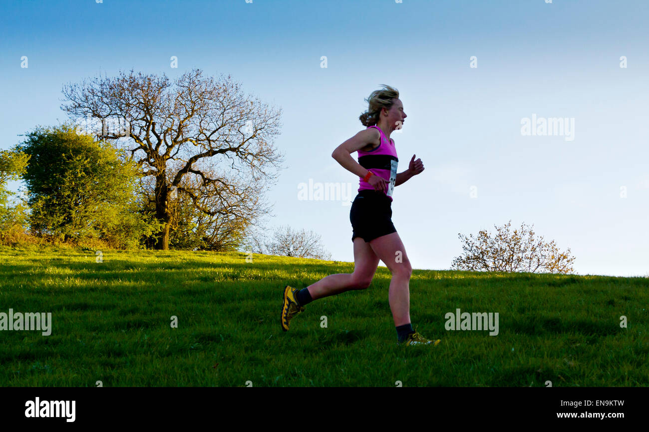 Fell racer cross country running across a hillside near Matlock Bath in