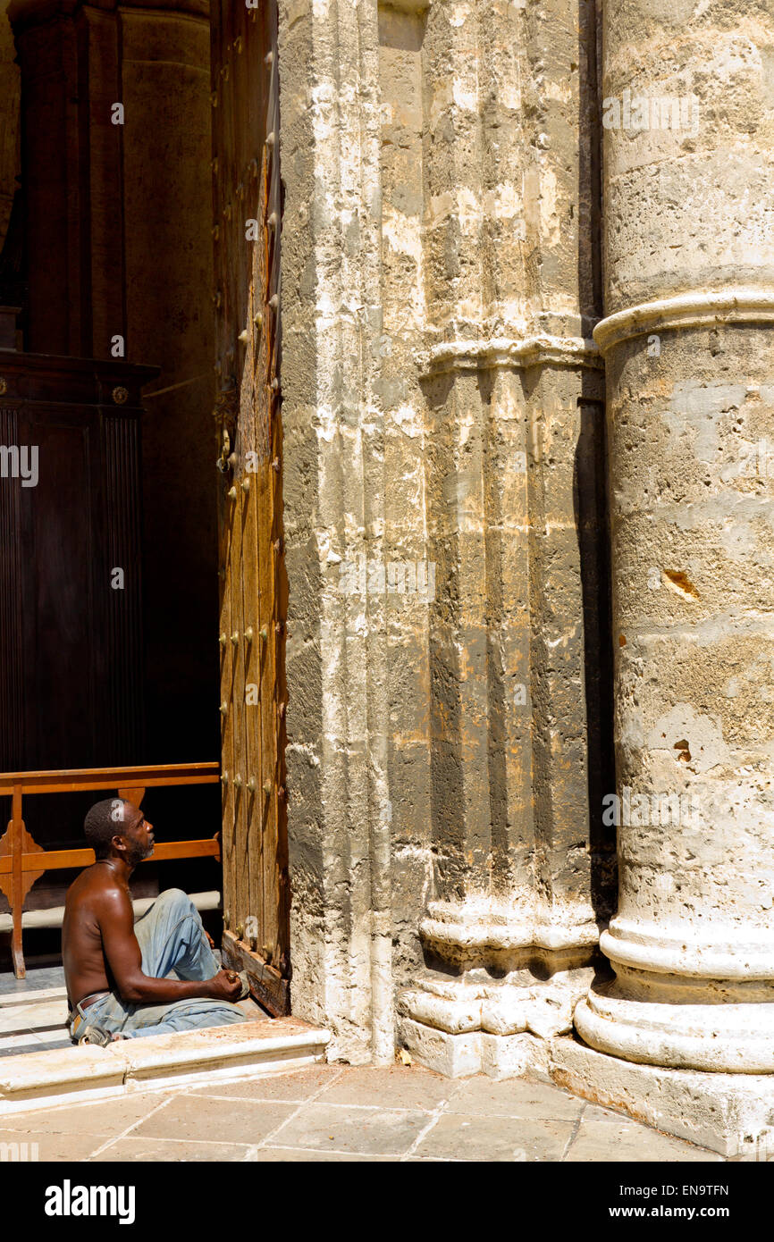 A man surveying the work he has been doing in the very hot sun in Old Havana Cuba Stock Photo