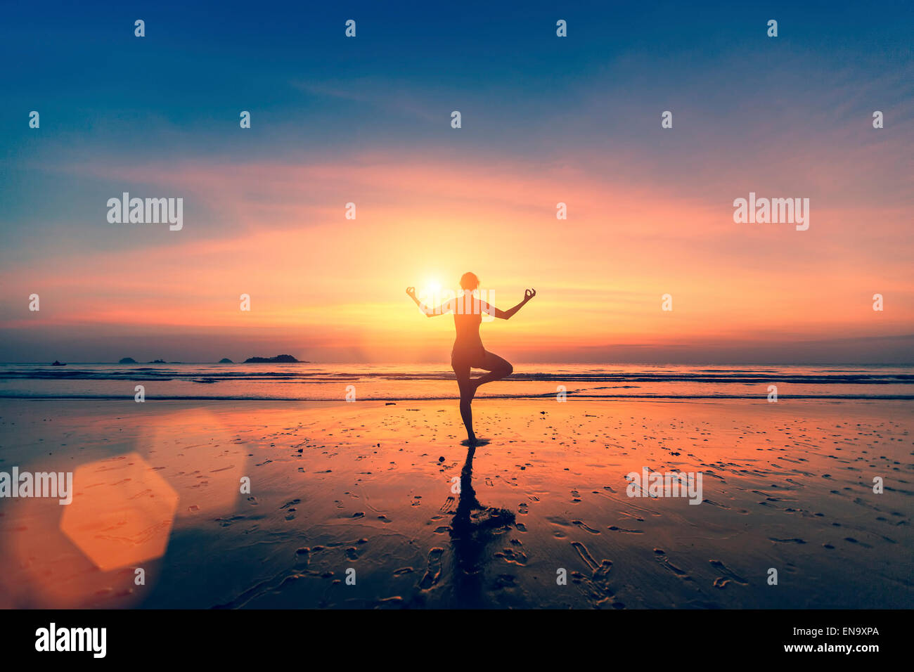 Silhouette of woman meditating on the sea beach. Yoga and fitness Stock ...