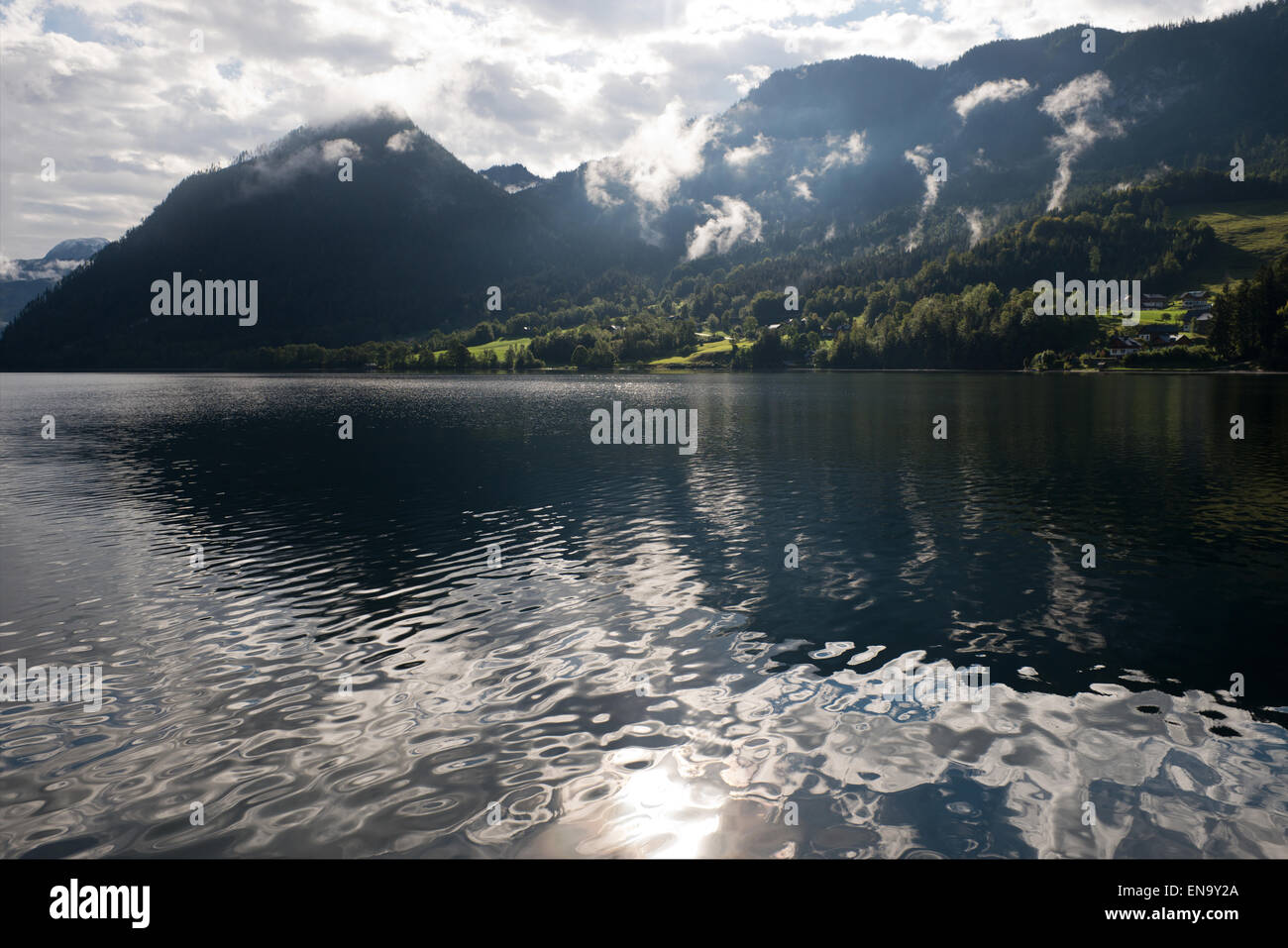 view over the lake and reflections of wafts of mist in Grundlsee after the rain, Styria, Austria Stock Photo