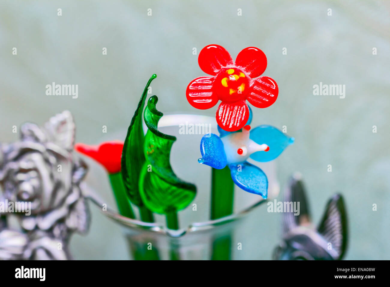 Nice glass flowers and scarlet flower in middle Stock Photo